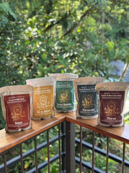 Five bags of coffee on a wooden surface with a blurred green outdoor background