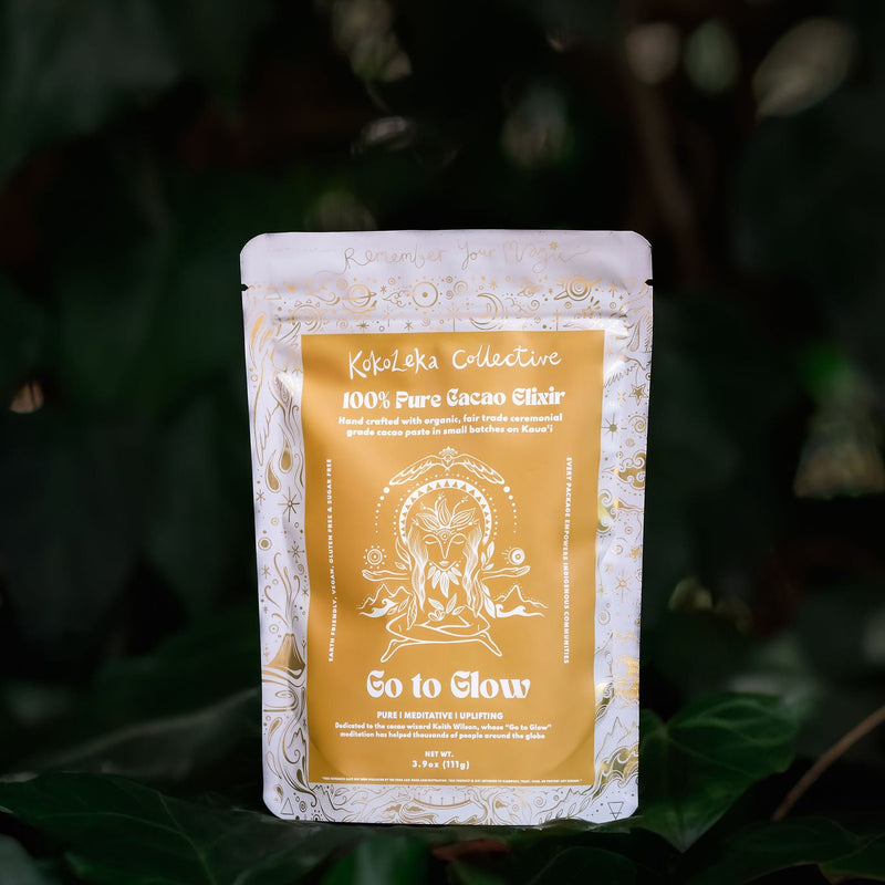 Kokoleka Collective cacao powder packaging on a dark green leafy background
